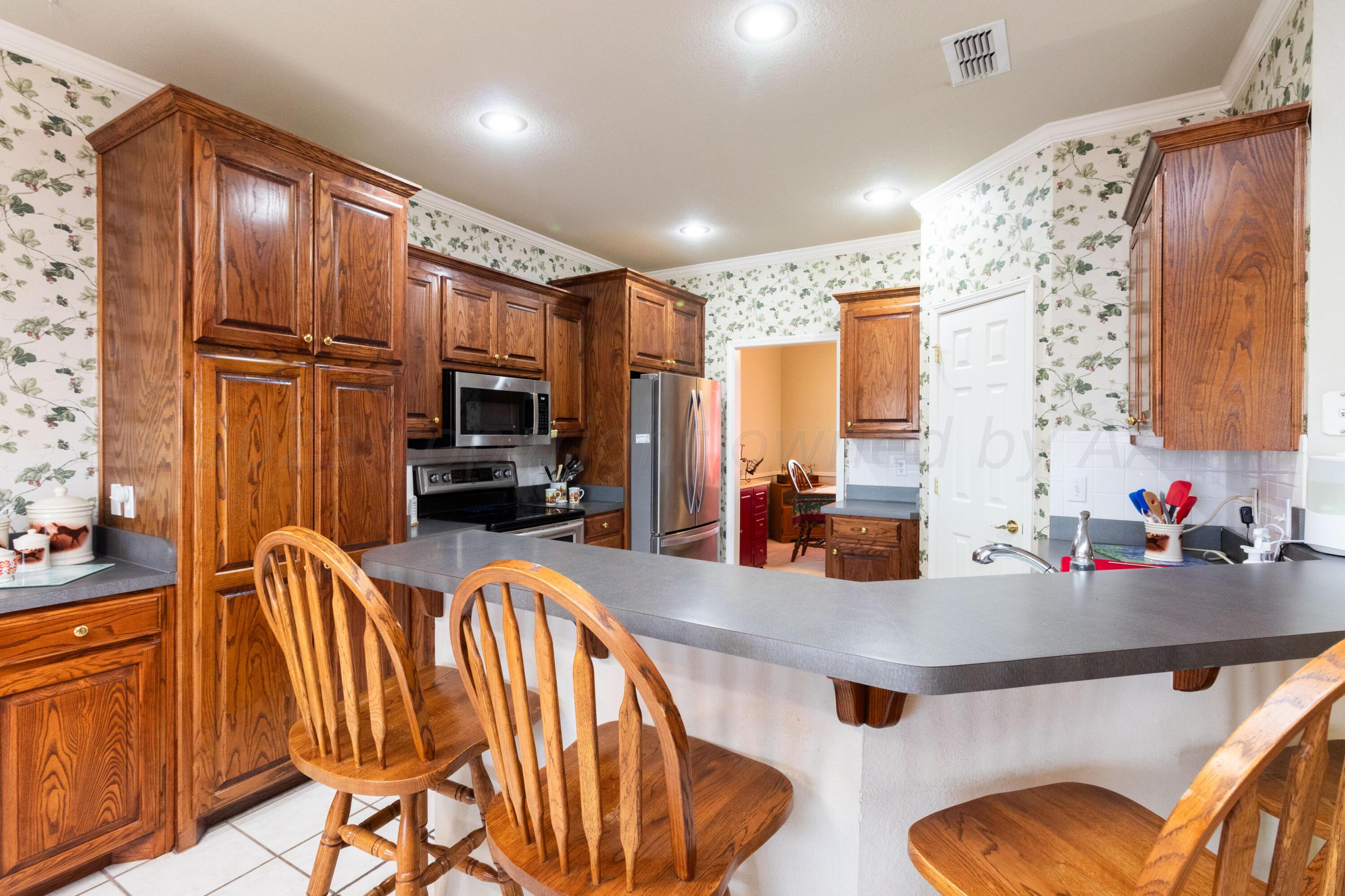 15212 Halsey Trail Amarillo, TX 79118 - Photo 17 of 47 a kitchen with stainless steel appliances granite countertop a refrigerator and countertop