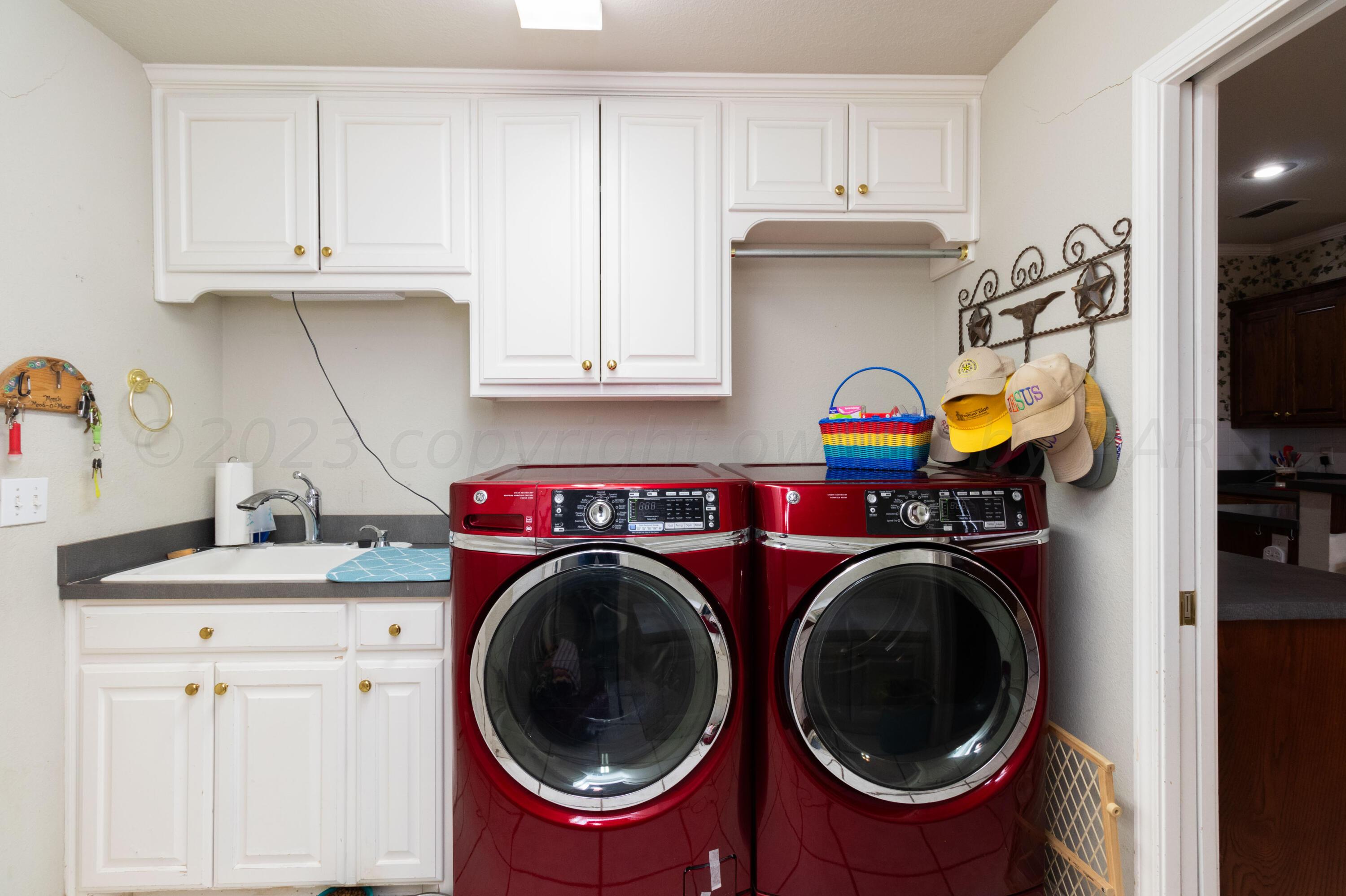 15212 Halsey Trail Amarillo, TX 79118 - Photo 20 of 47 a utility room with sink dryer and washer
