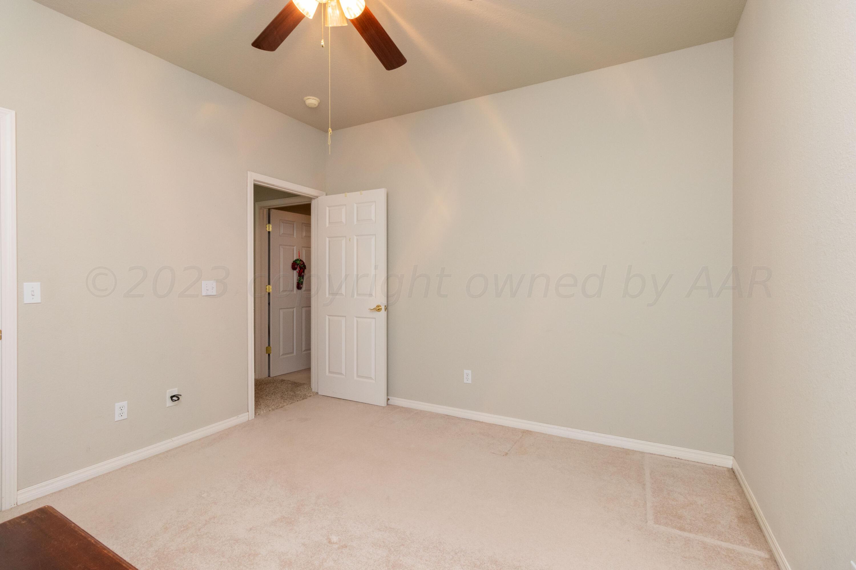 15212 Halsey Trail Amarillo, TX 79118 - Photo 22 of 47 an empty room with a chandelier fan and closet