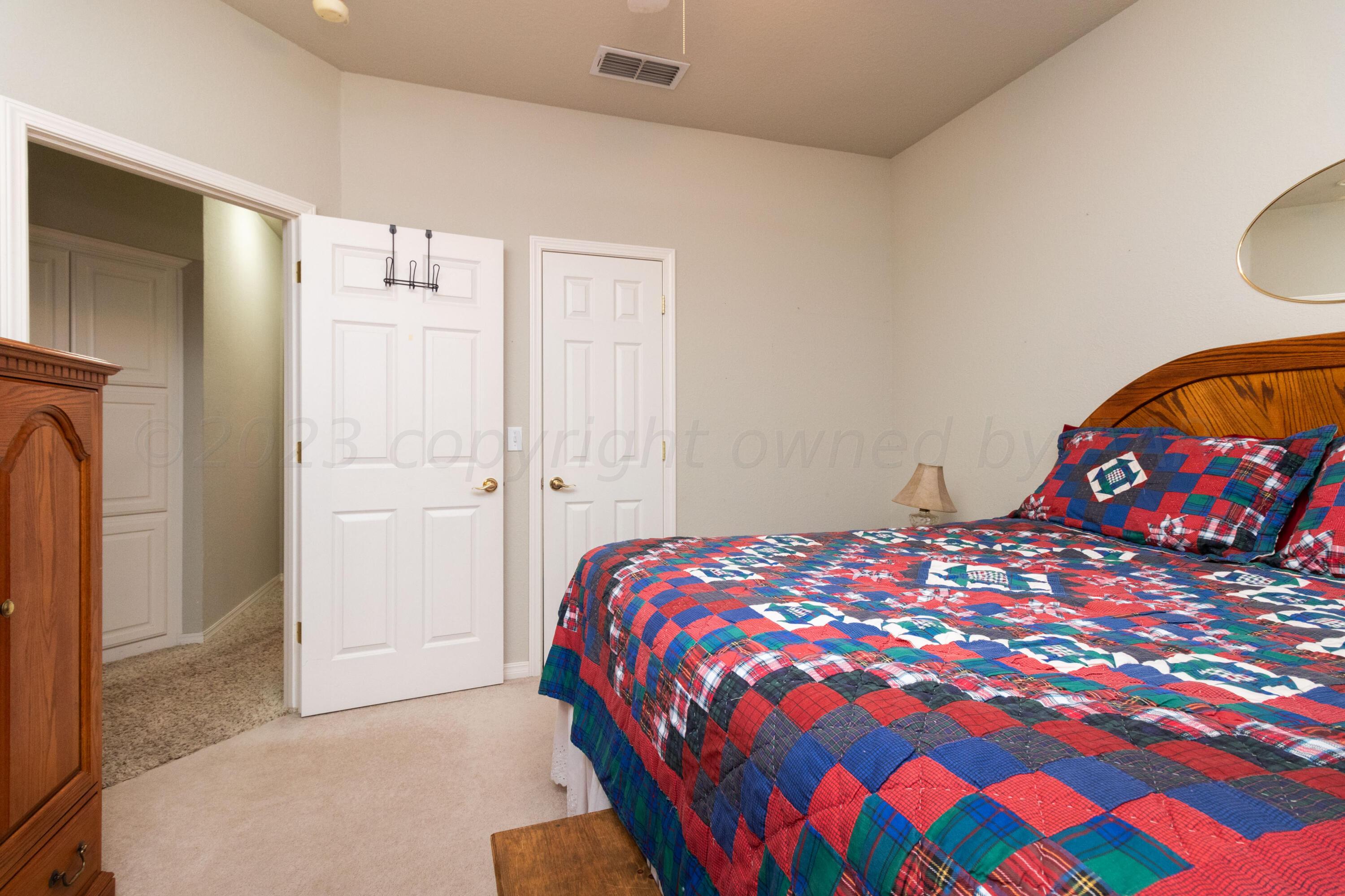 15212 Halsey Trail Amarillo, TX 79118 - Photo 27 of 47 a bedroom with a bed and a painting on the wall