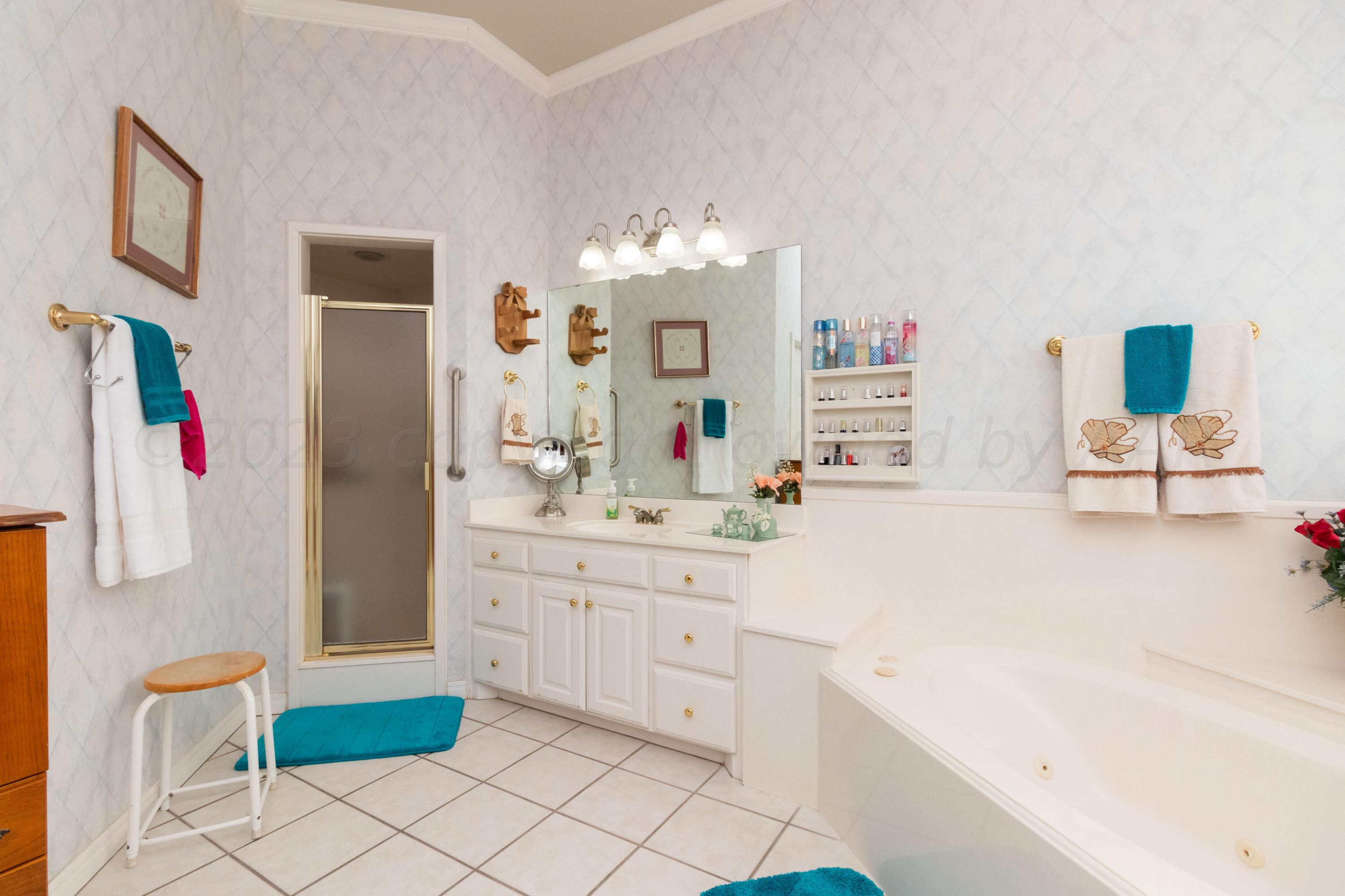 15212 Halsey Trail Amarillo, TX 79118 - Photo 31 of 47 a spacious bathroom with a sink double vanity and mirror