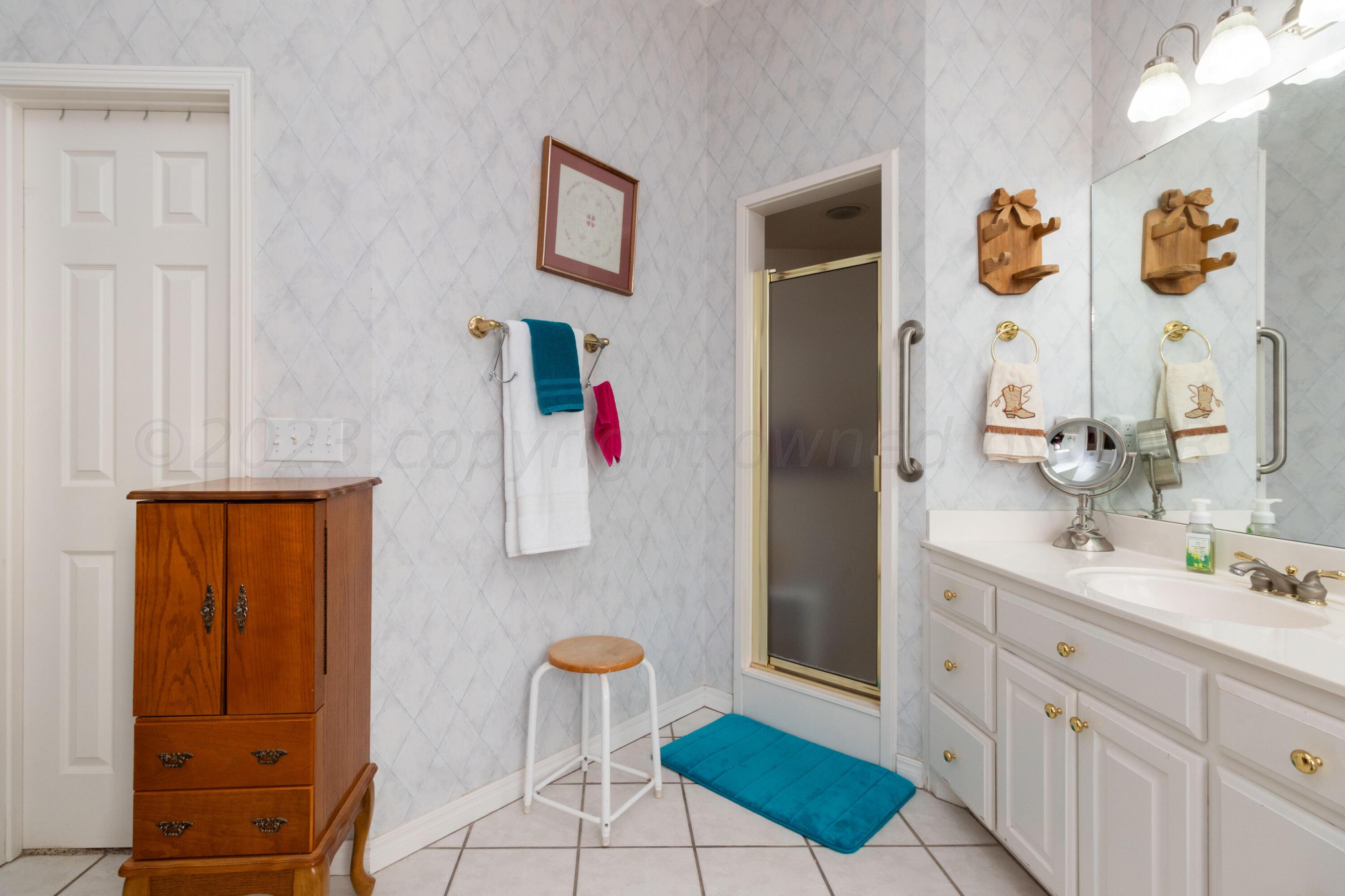 15212 Halsey Trail Amarillo, TX 79118 - Photo 34 of 47 a bathroom with a sink and a mirror
