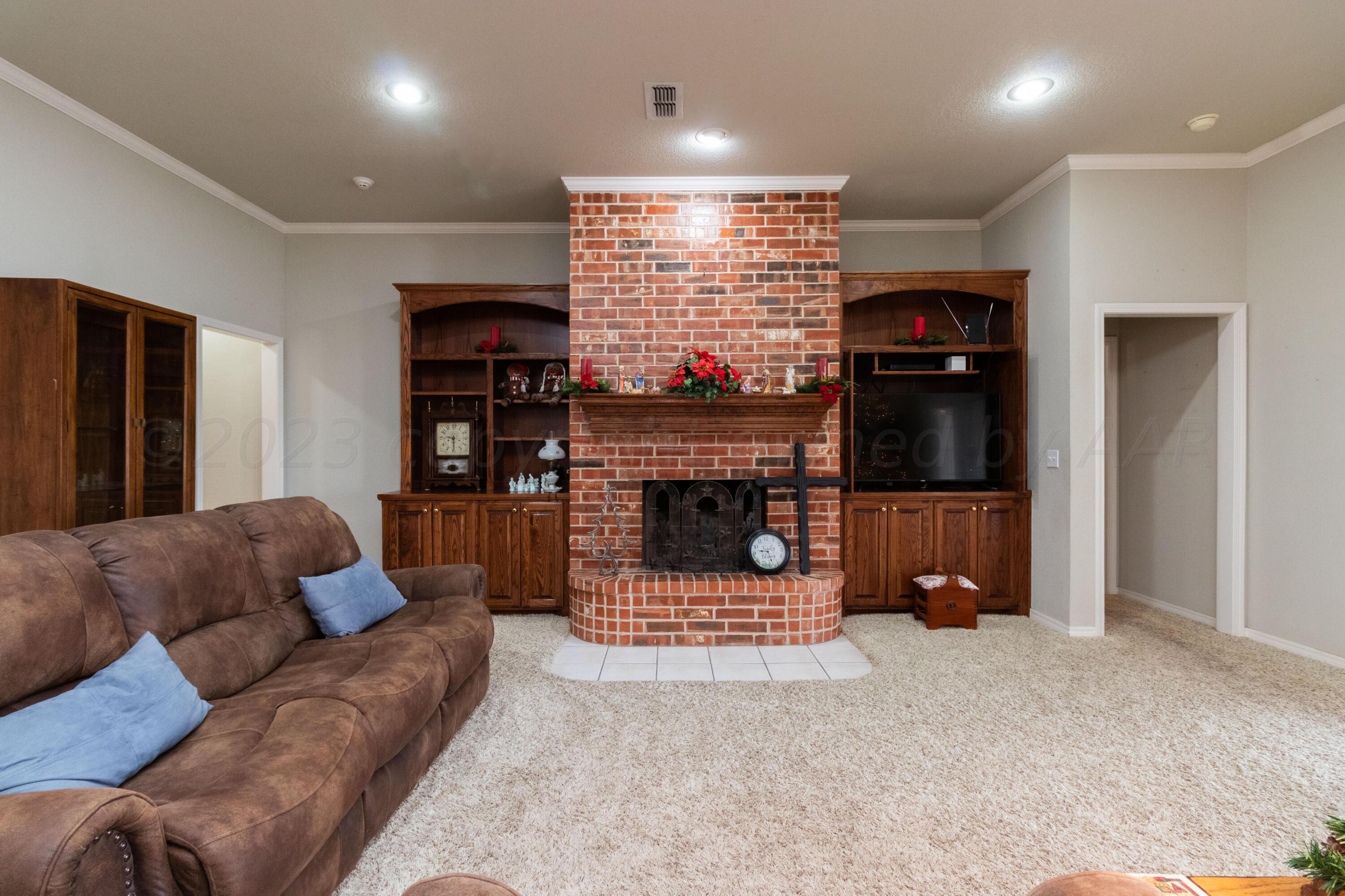 15212 Halsey Trail Amarillo, TX 79118 - Photo 7 of 47 a living room with furniture a fireplace and a flat screen tv