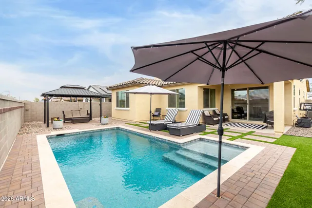 a view of a patio with swimming pool table and chairs
