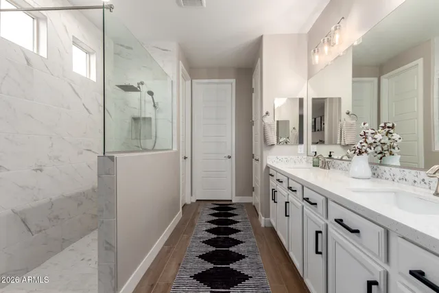 a bathroom with a double vanity sink and mirror
