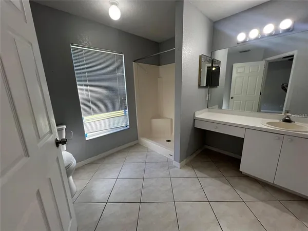 a bathroom with a sink a mirror and a shower