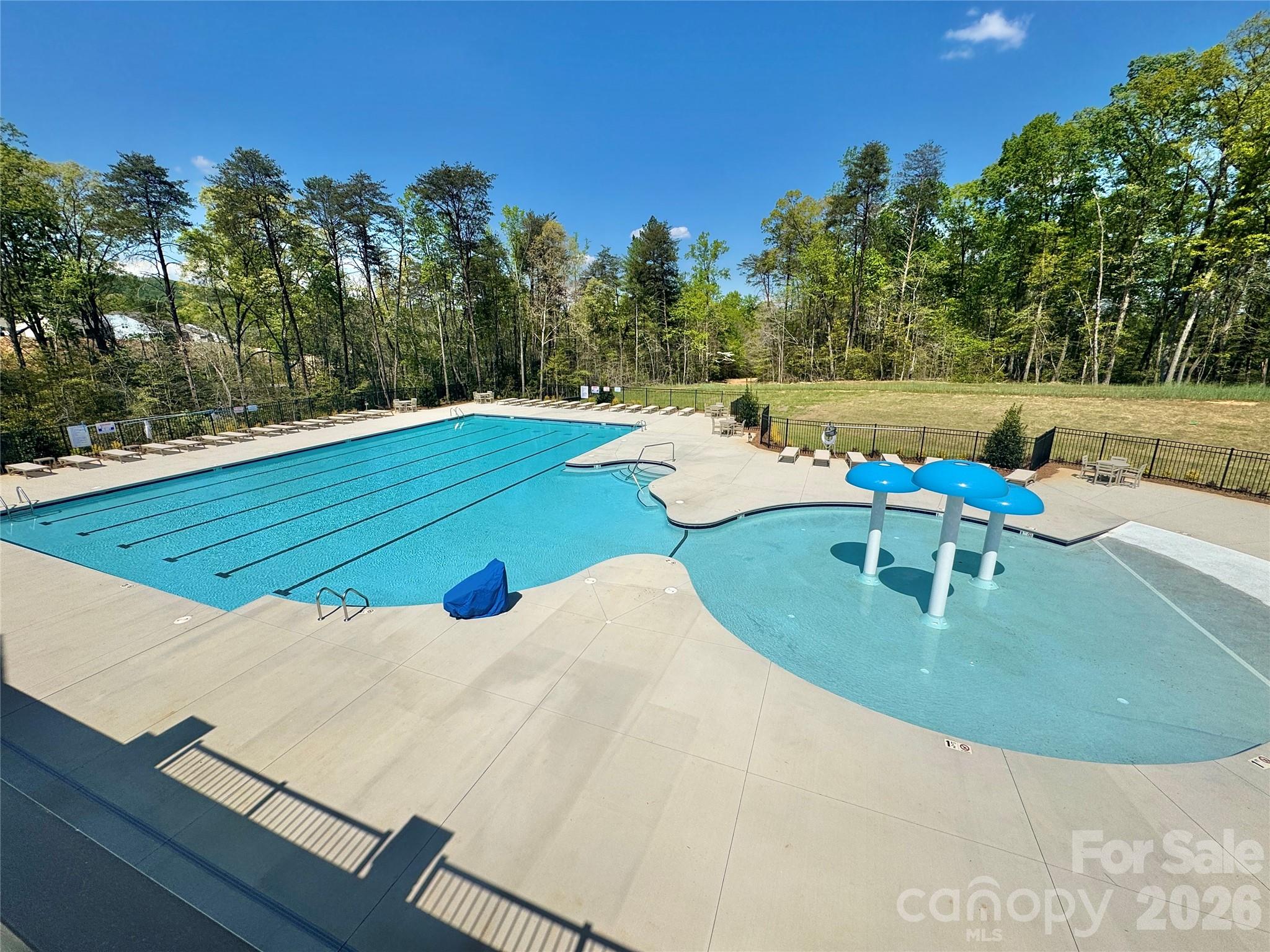 7032 Juneberry Way Maiden, NC 28650 - Photo 4 of 25 a view of a swimming pool with a yard and outdoor seating