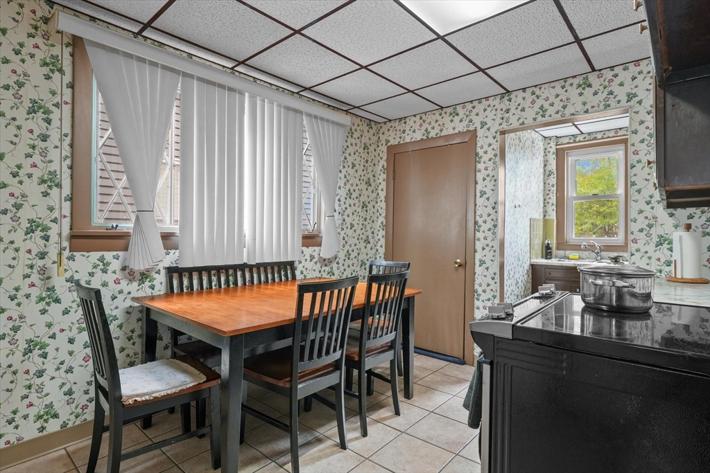 75 Grove Street Lynn, MA 01905 - Photo 11 of 38 a dining room with a wooden table and chairs