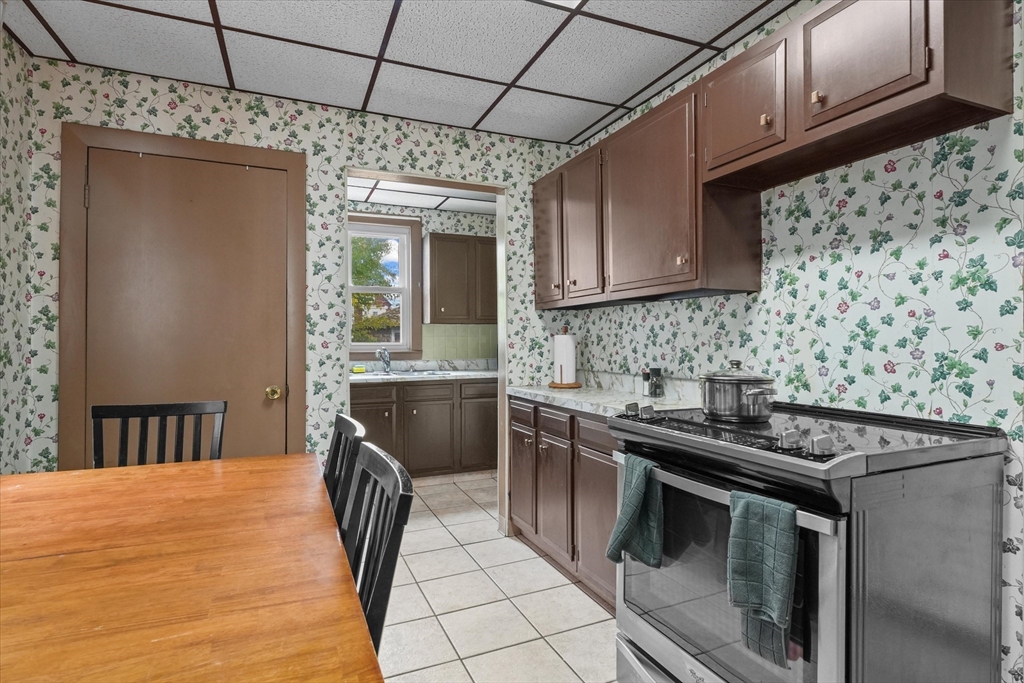 75 Grove Street Lynn, MA 01905 - Photo 12 of 38 a kitchen with stainless steel appliances granite countertop a sink stove and cabinets