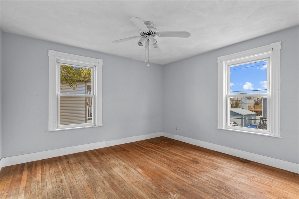 75 Grove Street Lynn, MA 01905 - Photo 15 of 38 a view of an empty room with wooden floor and a window
