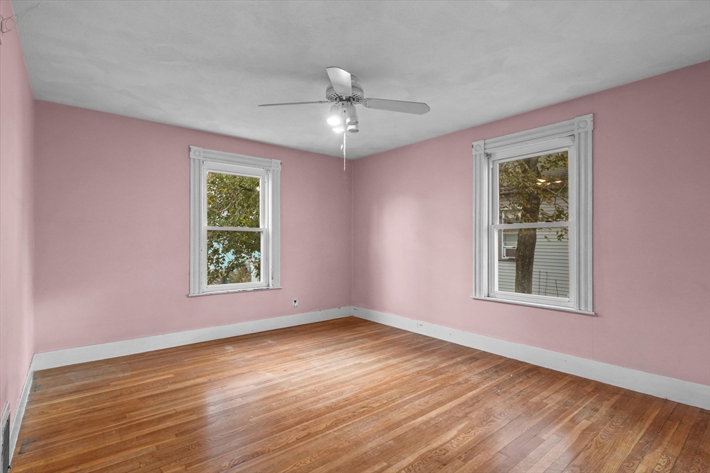 75 Grove Street Lynn, MA 01905 - Photo 17 of 38 a view of an empty room with wooden floor and a window