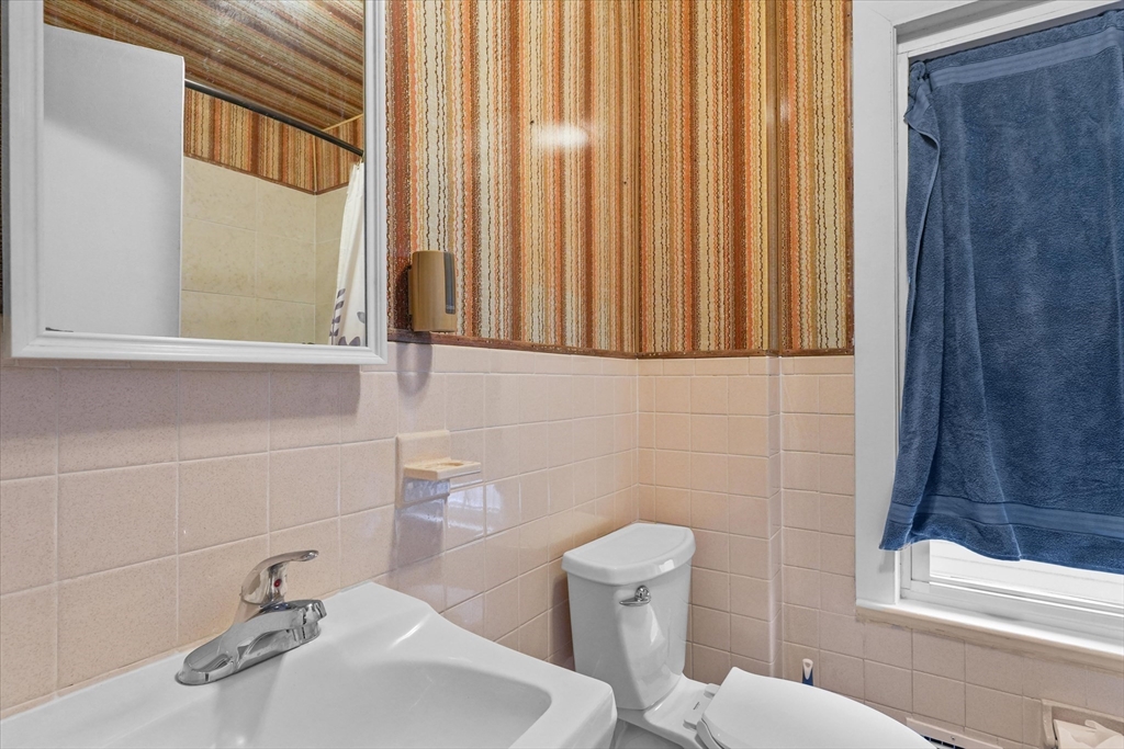75 Grove Street Lynn, MA 01905 - Photo 18 of 38 a bathroom with a sink a toilet and tub