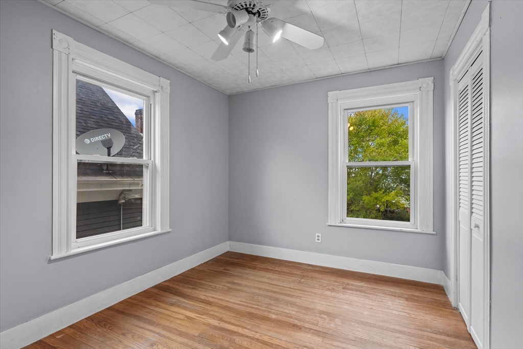 75 Grove Street Lynn, MA 01905 - Photo 19 of 38 a view of an empty room with a window and wooden floor