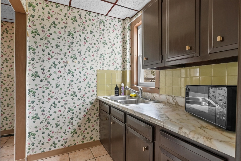 75 Grove Street Lynn, MA 01905 - Photo 8 of 38 a kitchen with a sink a stove and a microwave oven