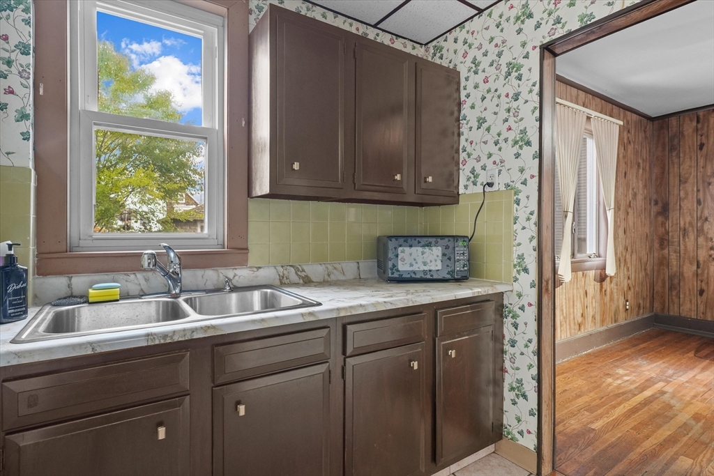 75 Grove Street Lynn, MA 01905 - Photo 9 of 38 a kitchen with a sink and cabinets