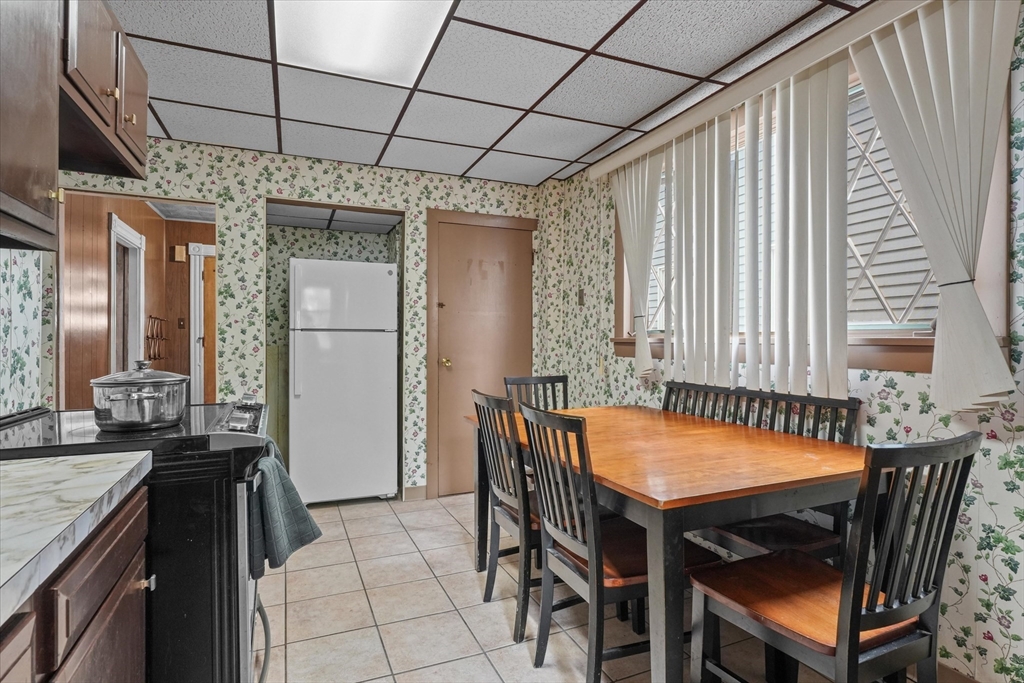 75 Grove Street Lynn, MA 01905 - Photo 10 of 38 a dining room with a wooden table and chairs