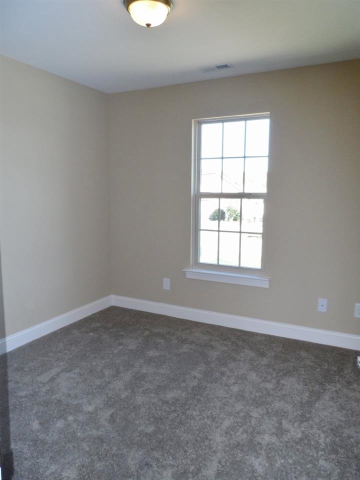 202 Orkney Road Stem, NC 27581 - Photo 17 of 25 an empty room with a window