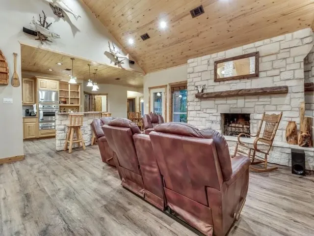 a kitchen with cabinets wooden floor and stainless steel appliances