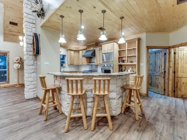 a dining room with furniture a chandelier and wooden floor