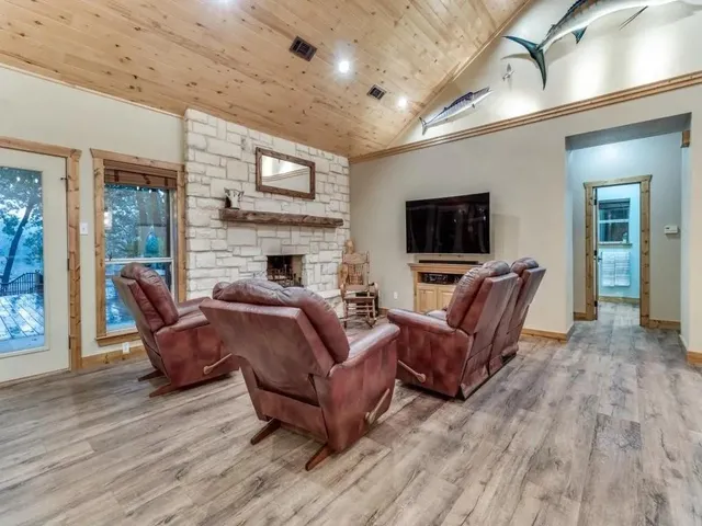 a kitchen with a stove and a wooden floor