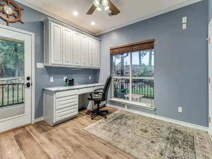 a kitchen with granite countertop a sink a stove and cabinets