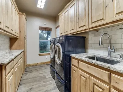 a large kitchen with a table and chairs in it
