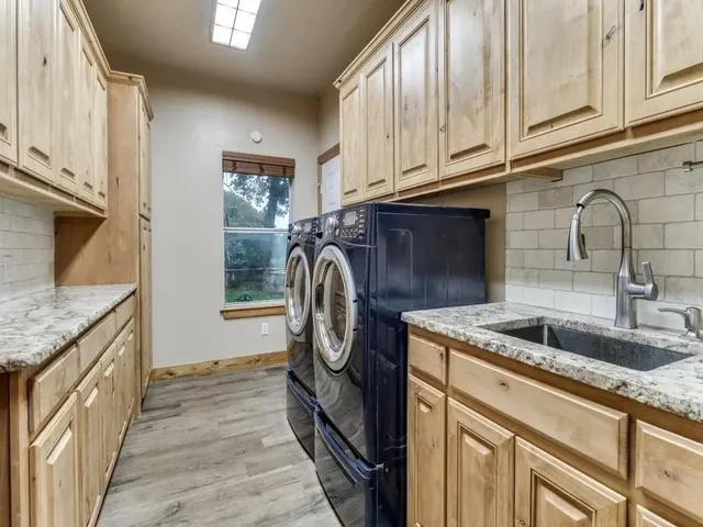 a large kitchen with a table and chairs in it