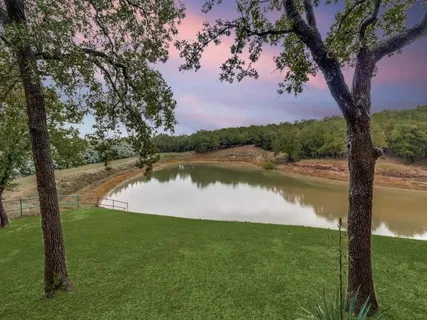 a view of a lake with houses in the back