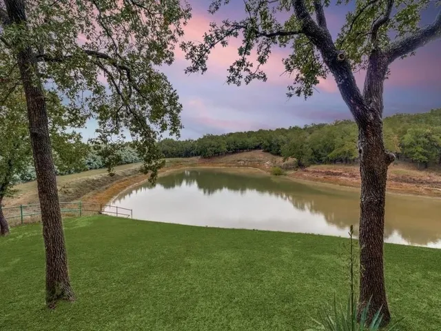 a view of a lake with houses in the back