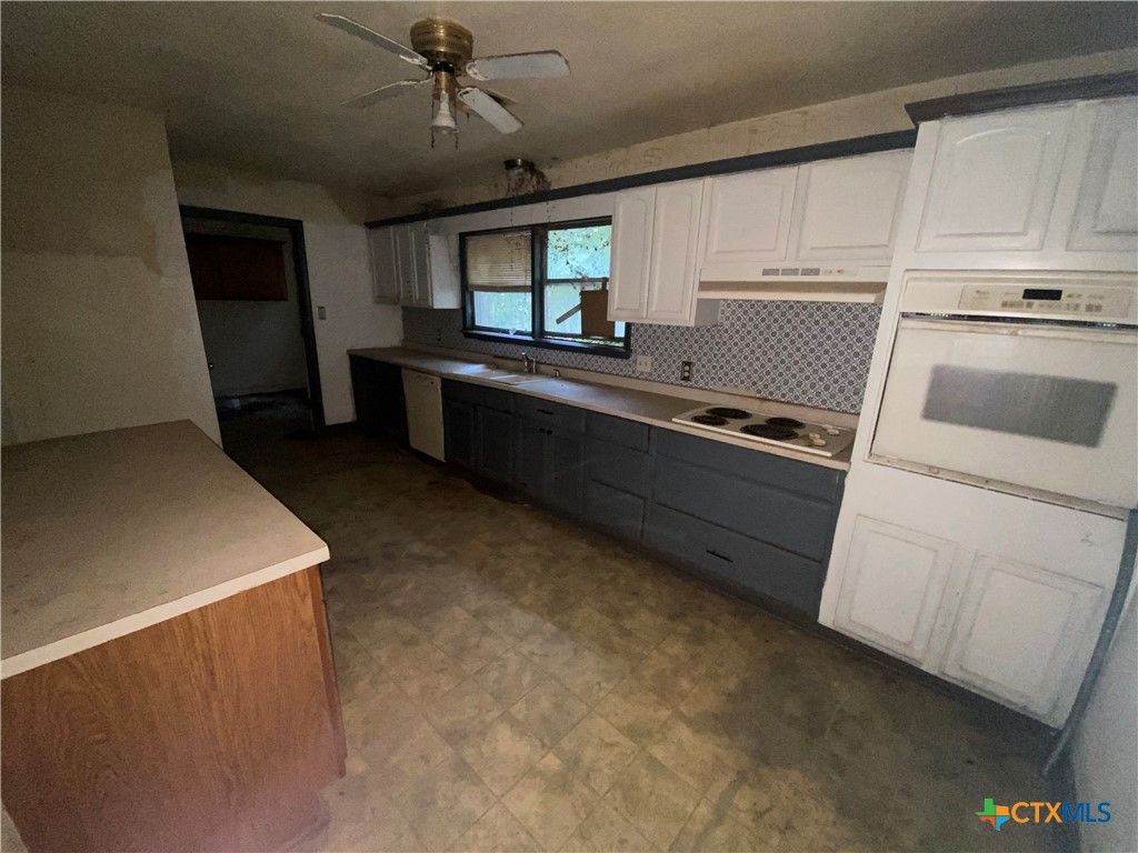 218 Cheeves Avenue Port Lavaca, TX 77979 - Photo 15 of 25 a kitchen with sink cabinets and window