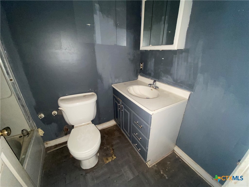 218 Cheeves Avenue Port Lavaca, TX 77979 - Photo 20 of 25 a bathroom with a sink toilet and mirror