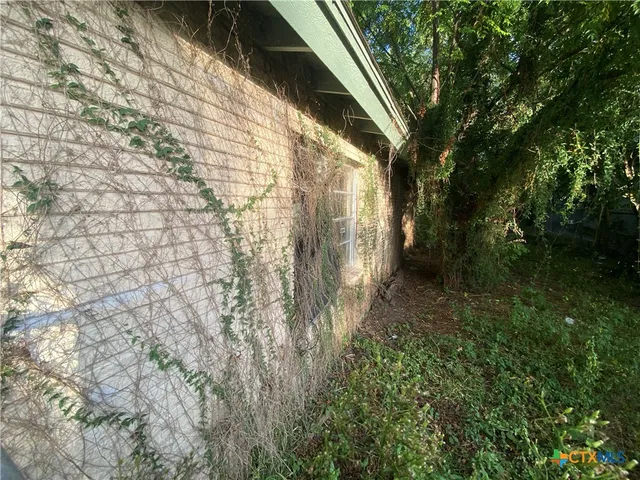 a backyard of a house with lots of green space and shower