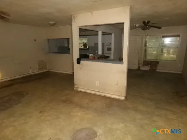 a view of a kitchen cabinets and a refrigerator