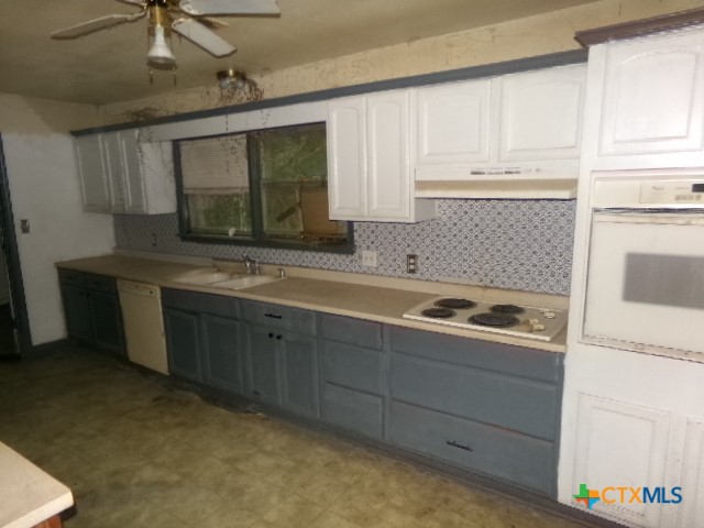 218 Cheeves Avenue Port Lavaca, TX 77979 - Photo 8 of 25 a kitchen with stainless steel appliances granite countertop a sink stove and cabinets