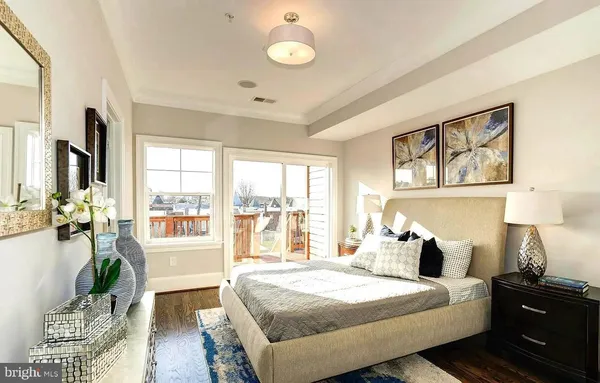a bedroom with a large bed and a large window
