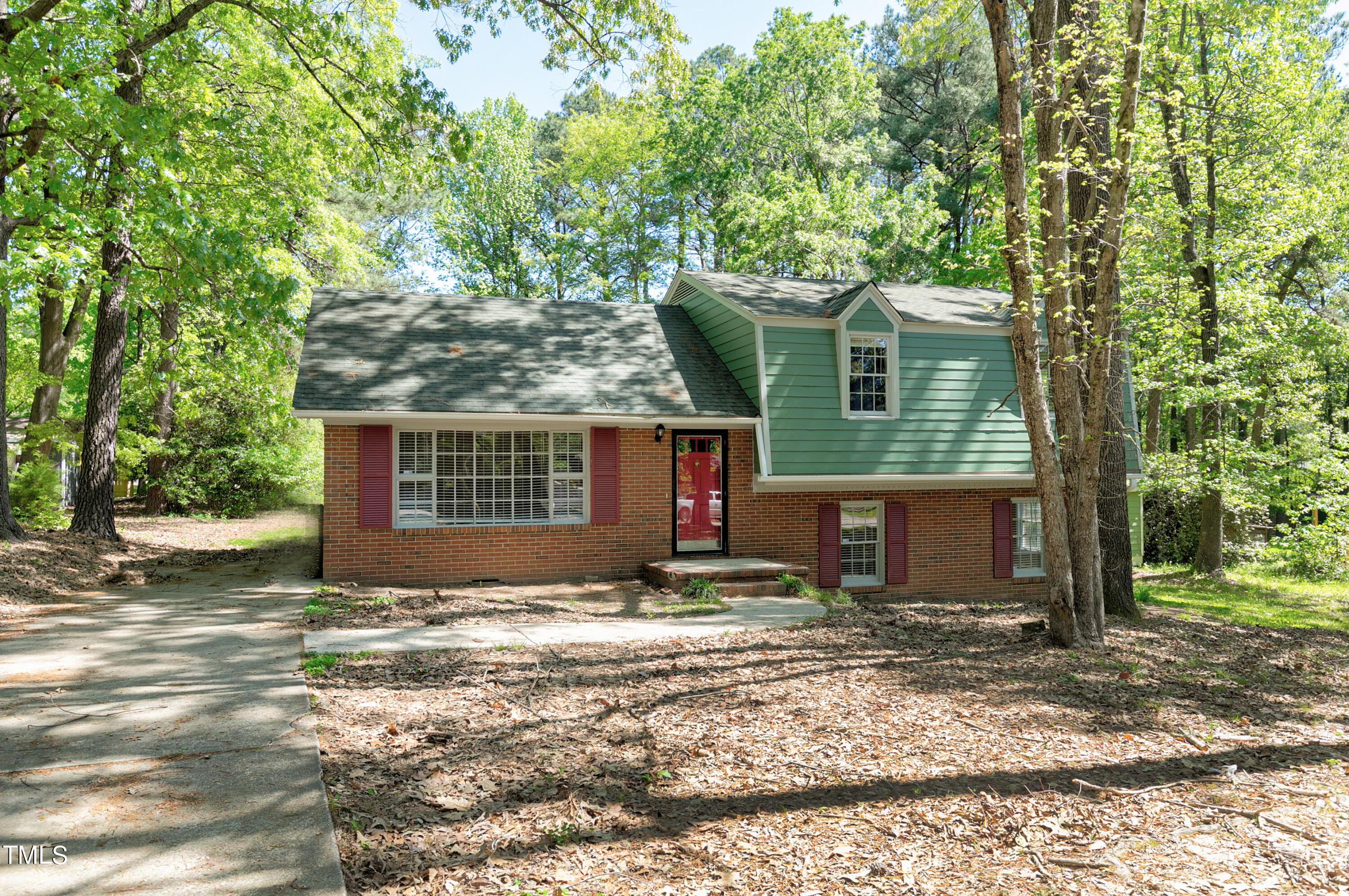 5841 Sandstone Drive Durham, NC 27713 - Photo 1 of 35 a view of a house with a yard tree and wooden fence