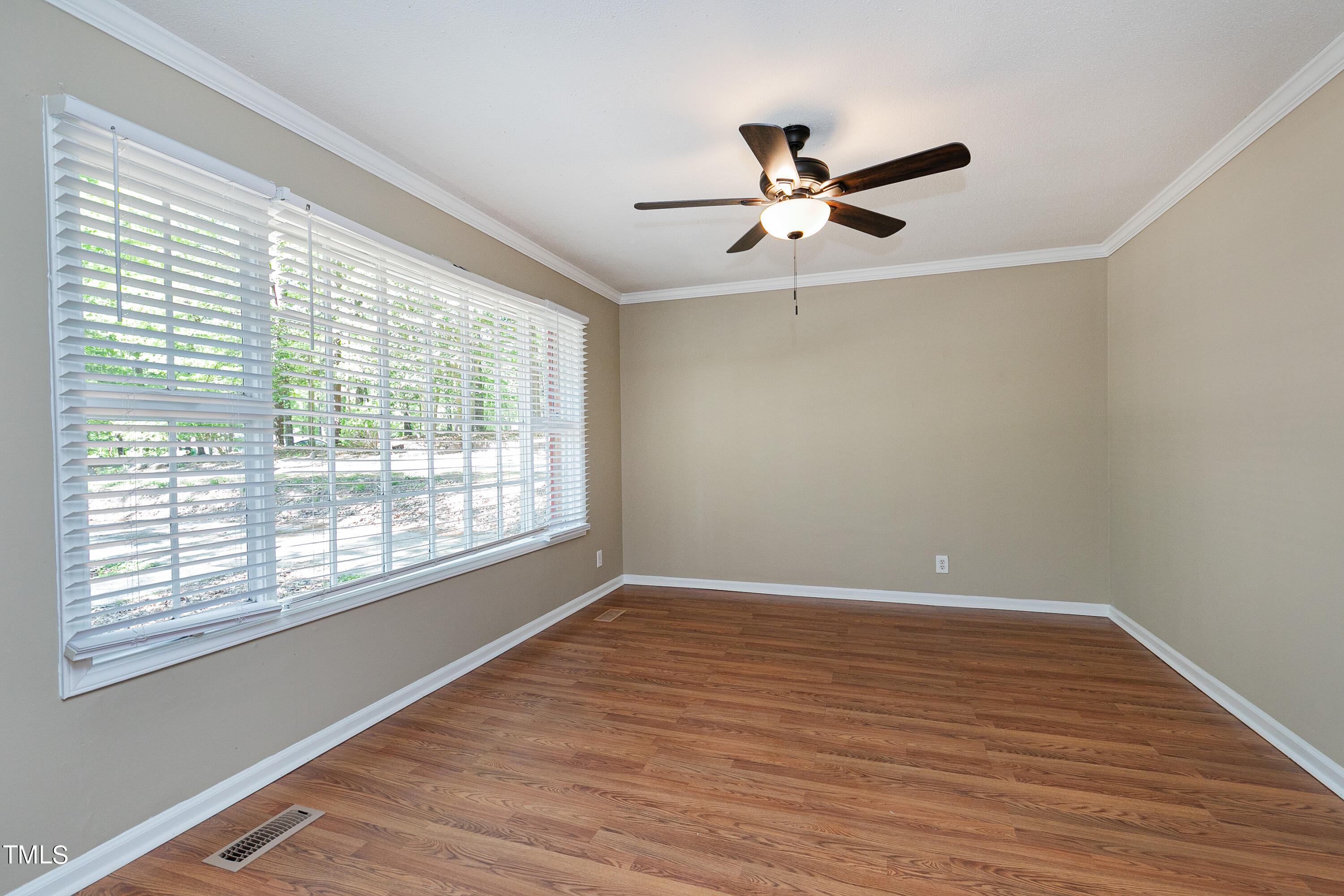 5841 Sandstone Drive Durham, NC 27713 - Photo 11 of 35 a view of an empty room with wooden floor and a window