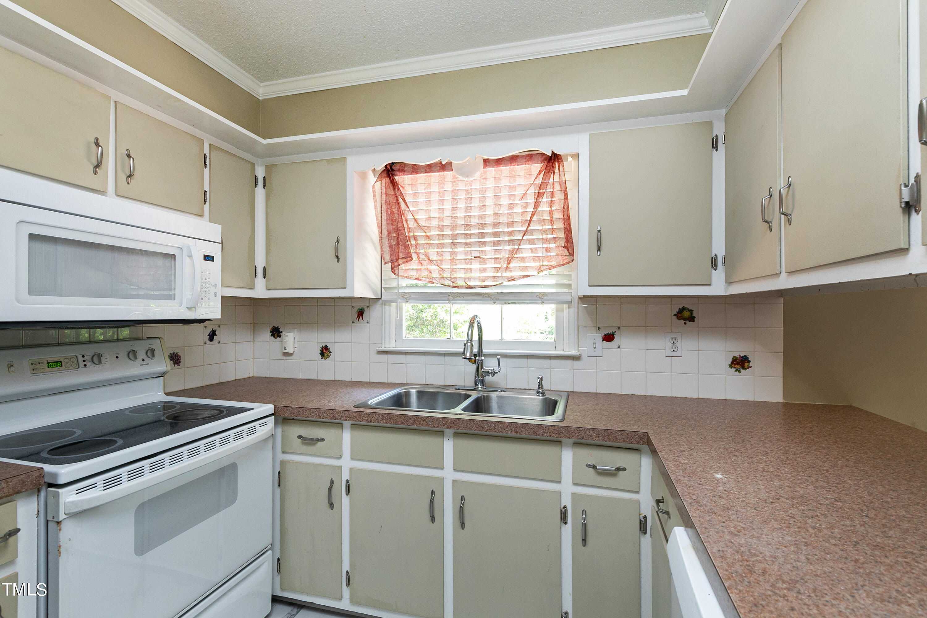 5841 Sandstone Drive Durham, NC 27713 - Photo 15 of 35 a kitchen with a sink stove and cabinets