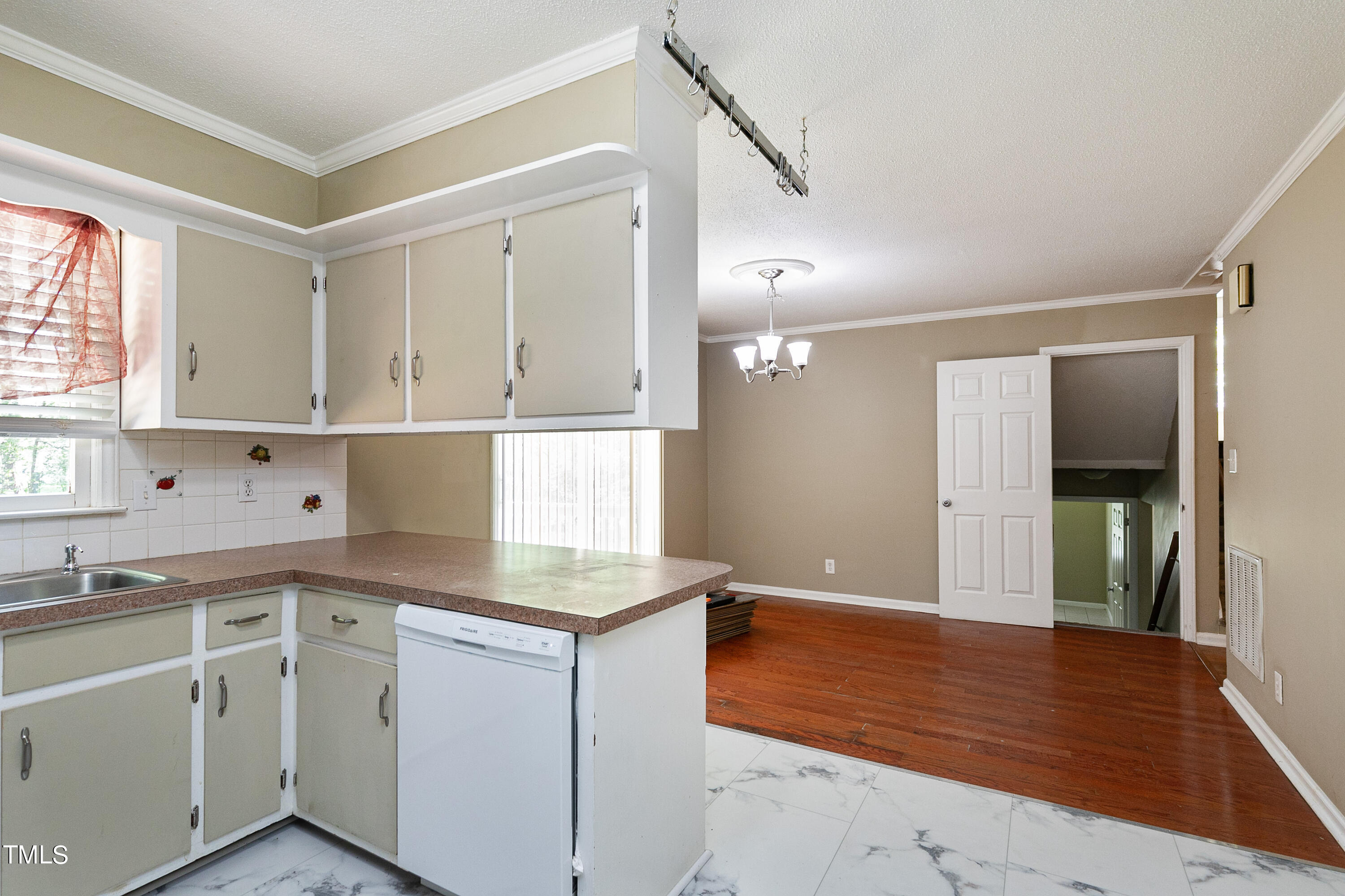 5841 Sandstone Drive Durham, NC 27713 - Photo 16 of 35 a kitchen with granite countertop white cabinets and white appliances
