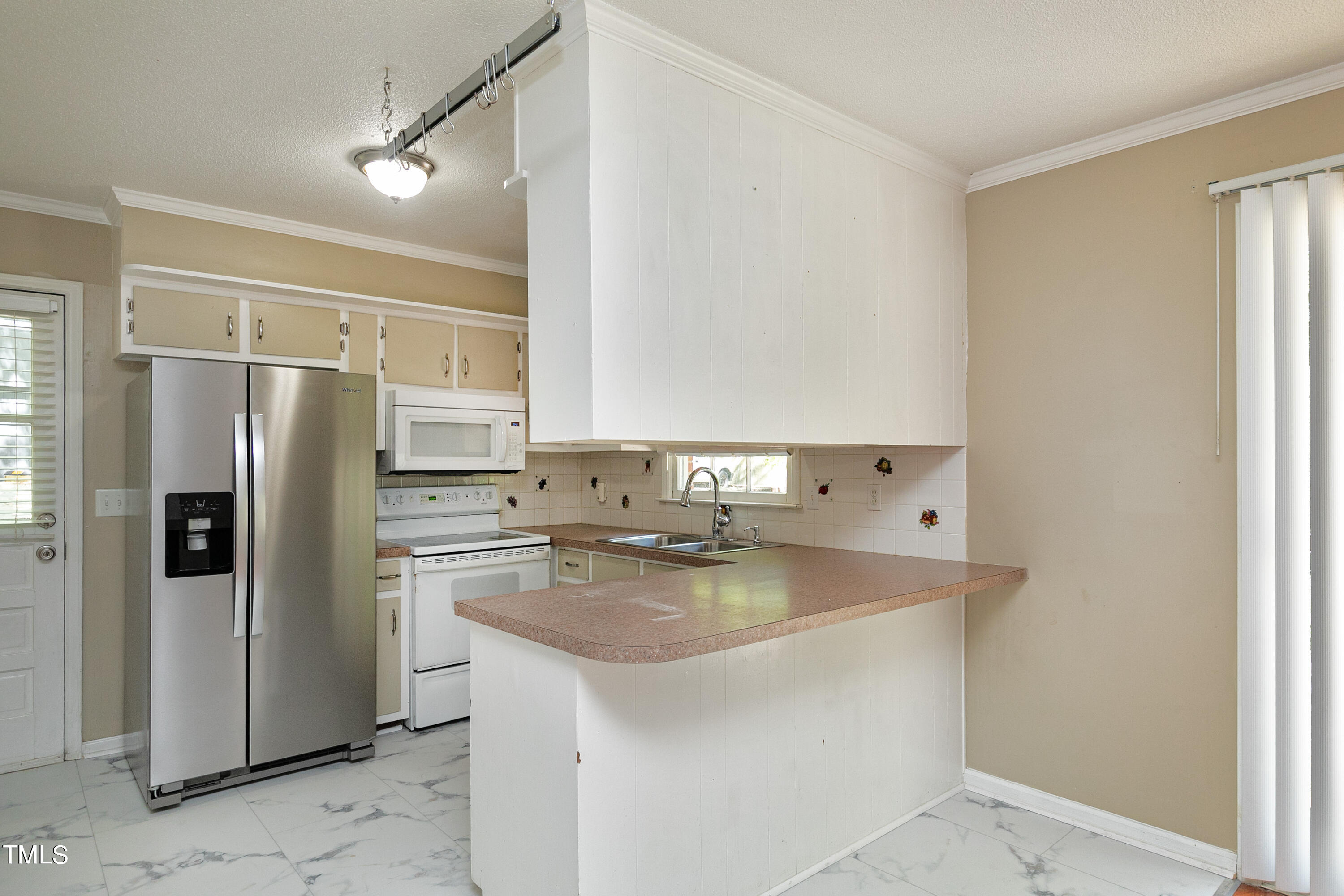 5841 Sandstone Drive Durham, NC 27713 - Photo 17 of 35 a kitchen with stainless steel appliances granite countertop a refrigerator sink and cabinets