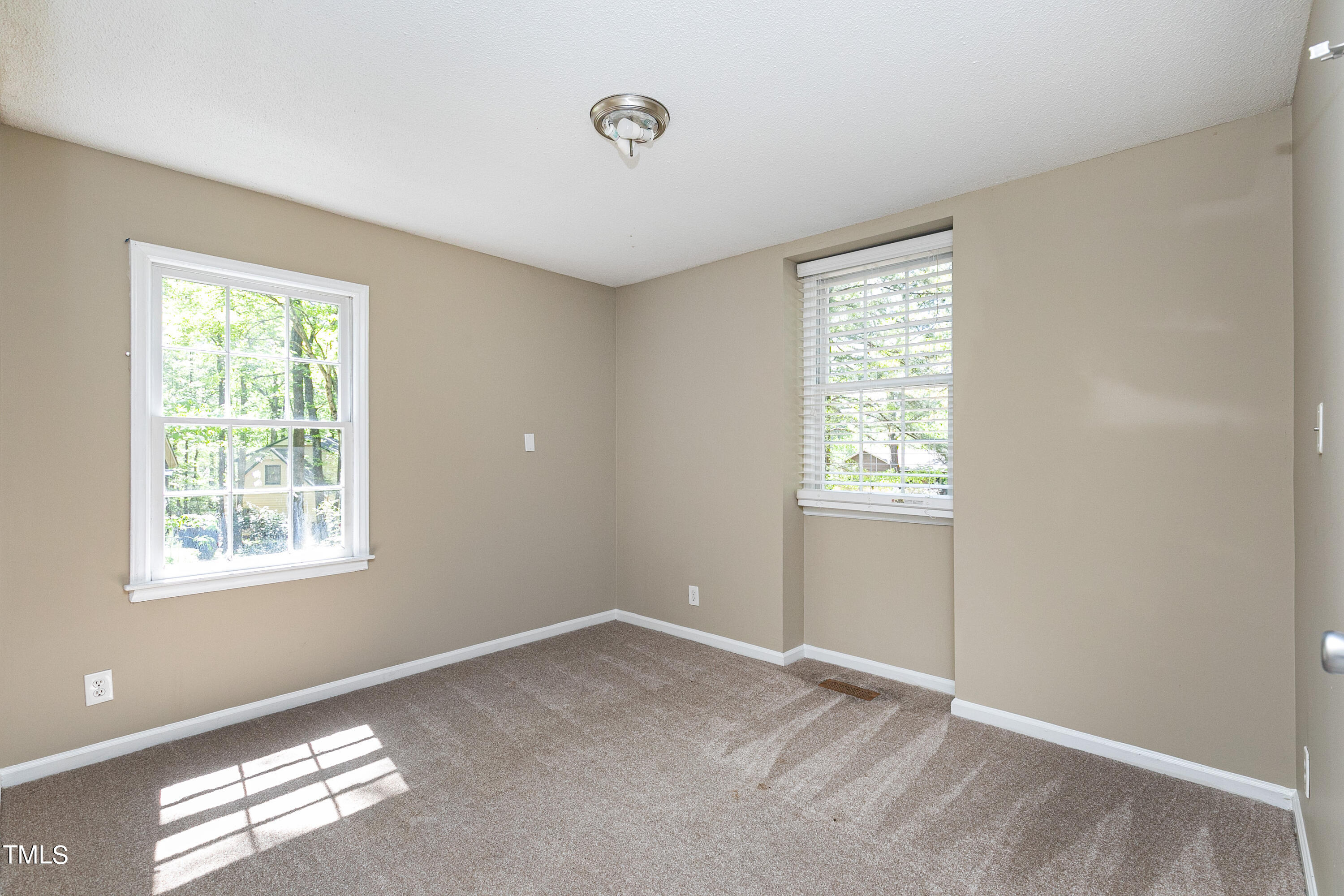 5841 Sandstone Drive Durham, NC 27713 - Photo 18 of 35 a view of an empty room with a window