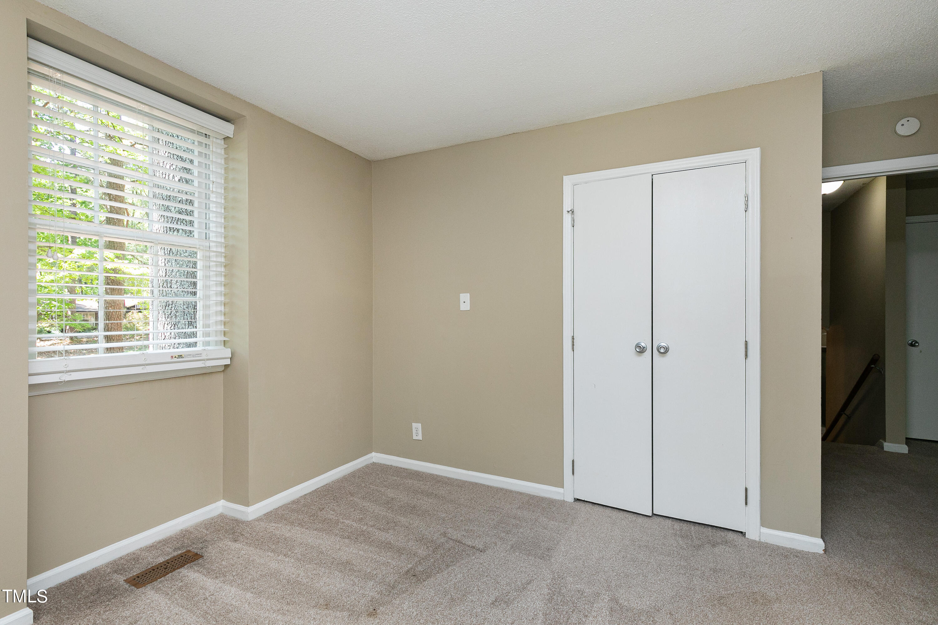 5841 Sandstone Drive Durham, NC 27713 - Photo 19 of 35 a view of an empty room with a window