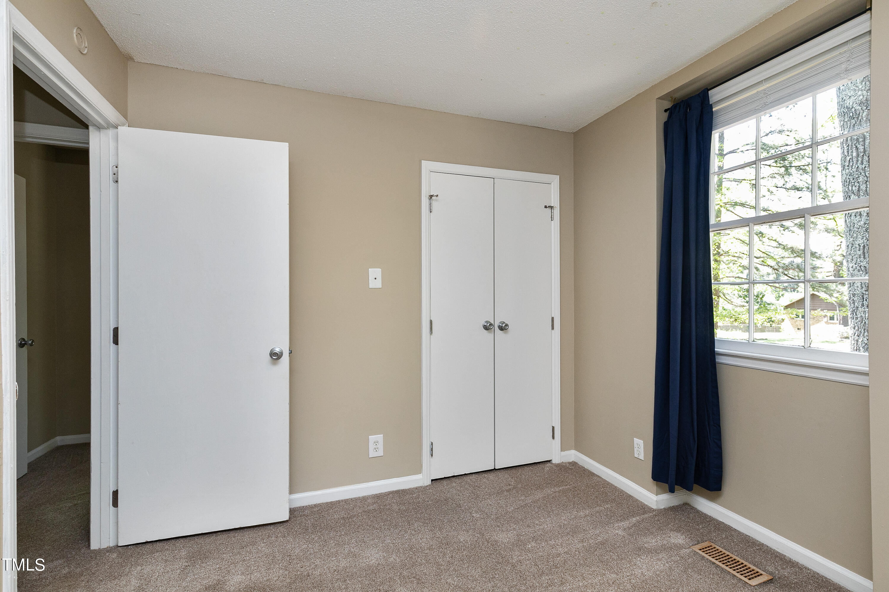 5841 Sandstone Drive Durham, NC 27713 - Photo 21 of 35 a view of an empty room with a window