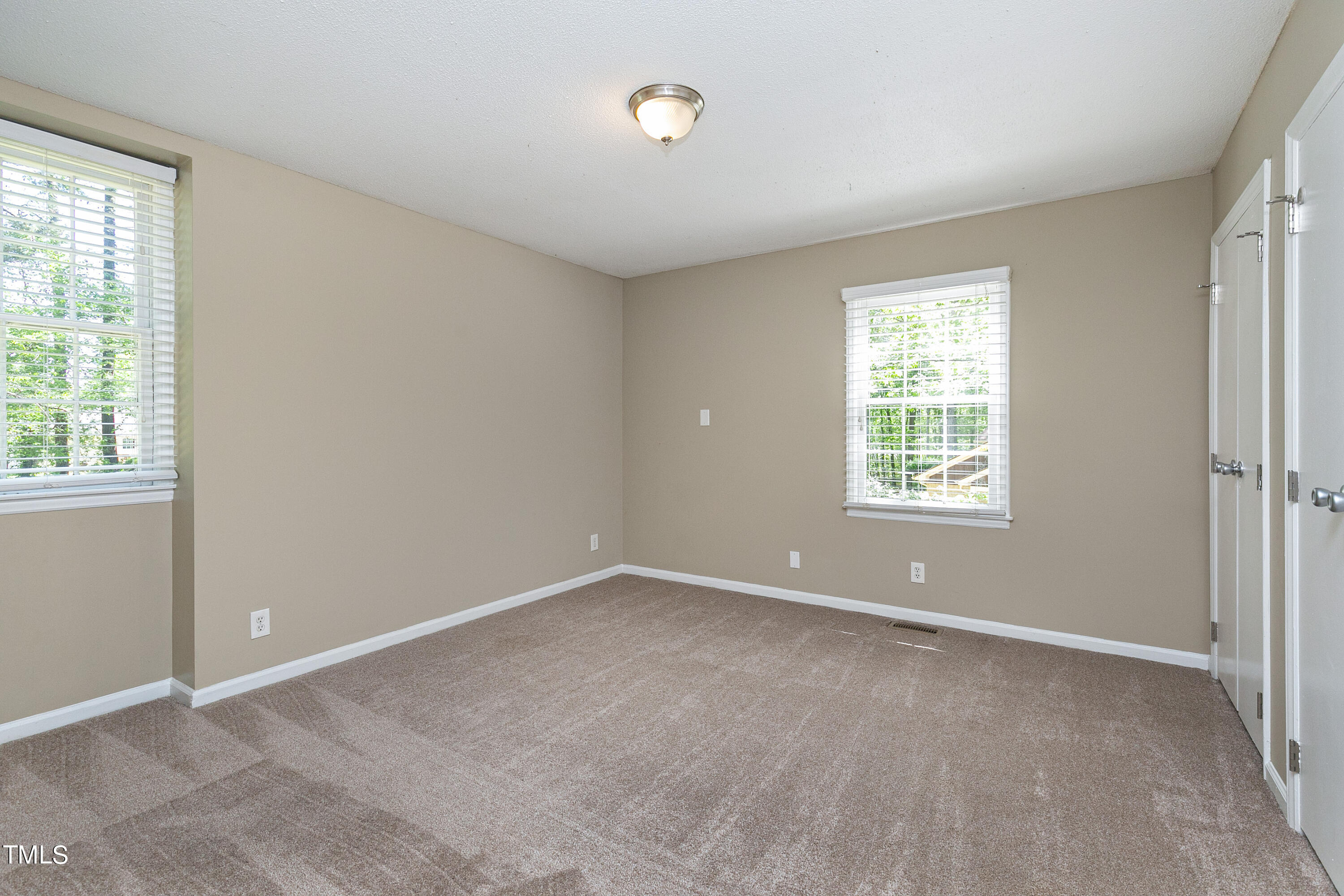 5841 Sandstone Drive Durham, NC 27713 - Photo 22 of 35 an empty room with windows and closet