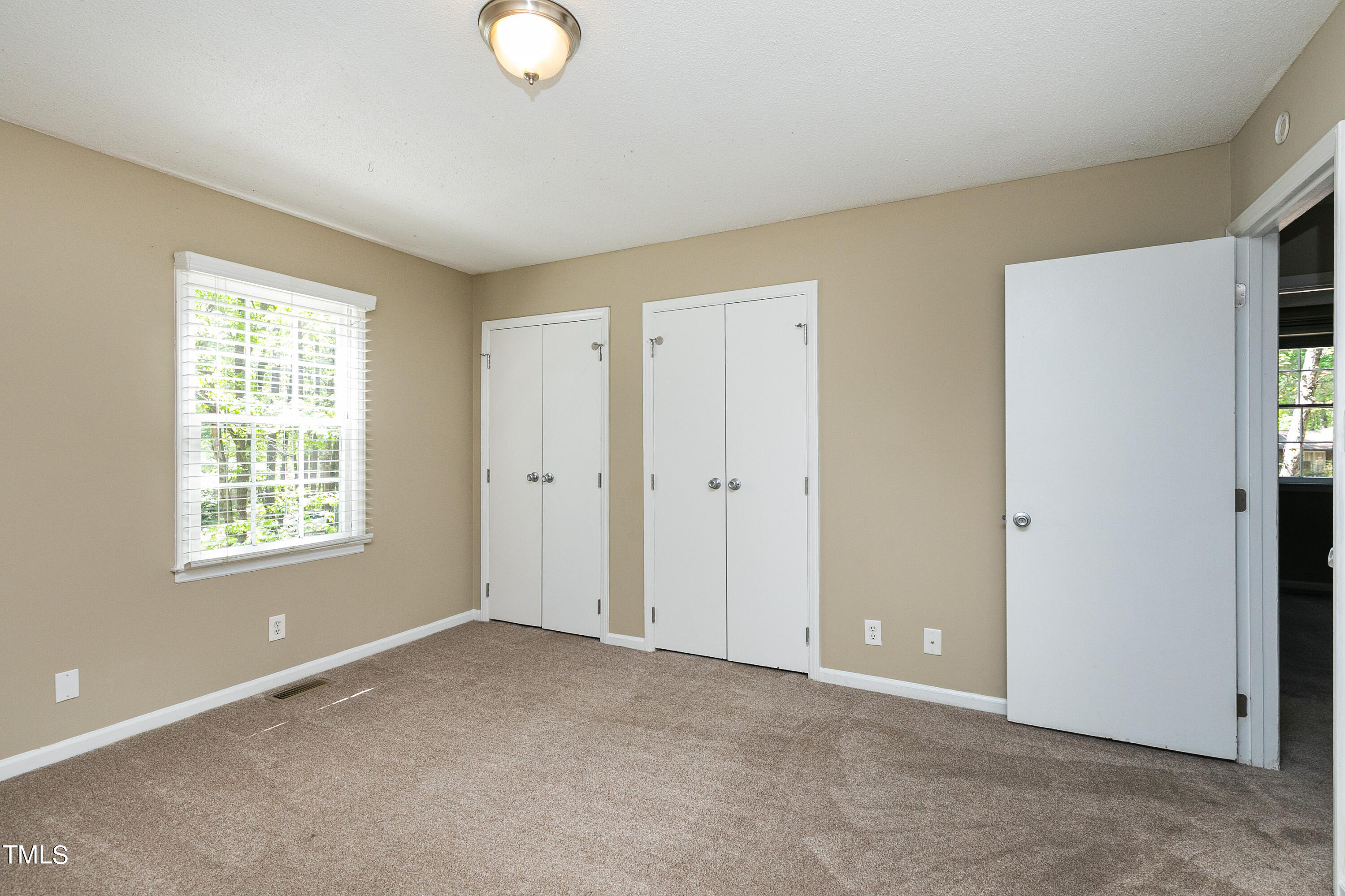 5841 Sandstone Drive Durham, NC 27713 - Photo 23 of 35 a view of an empty room with a window