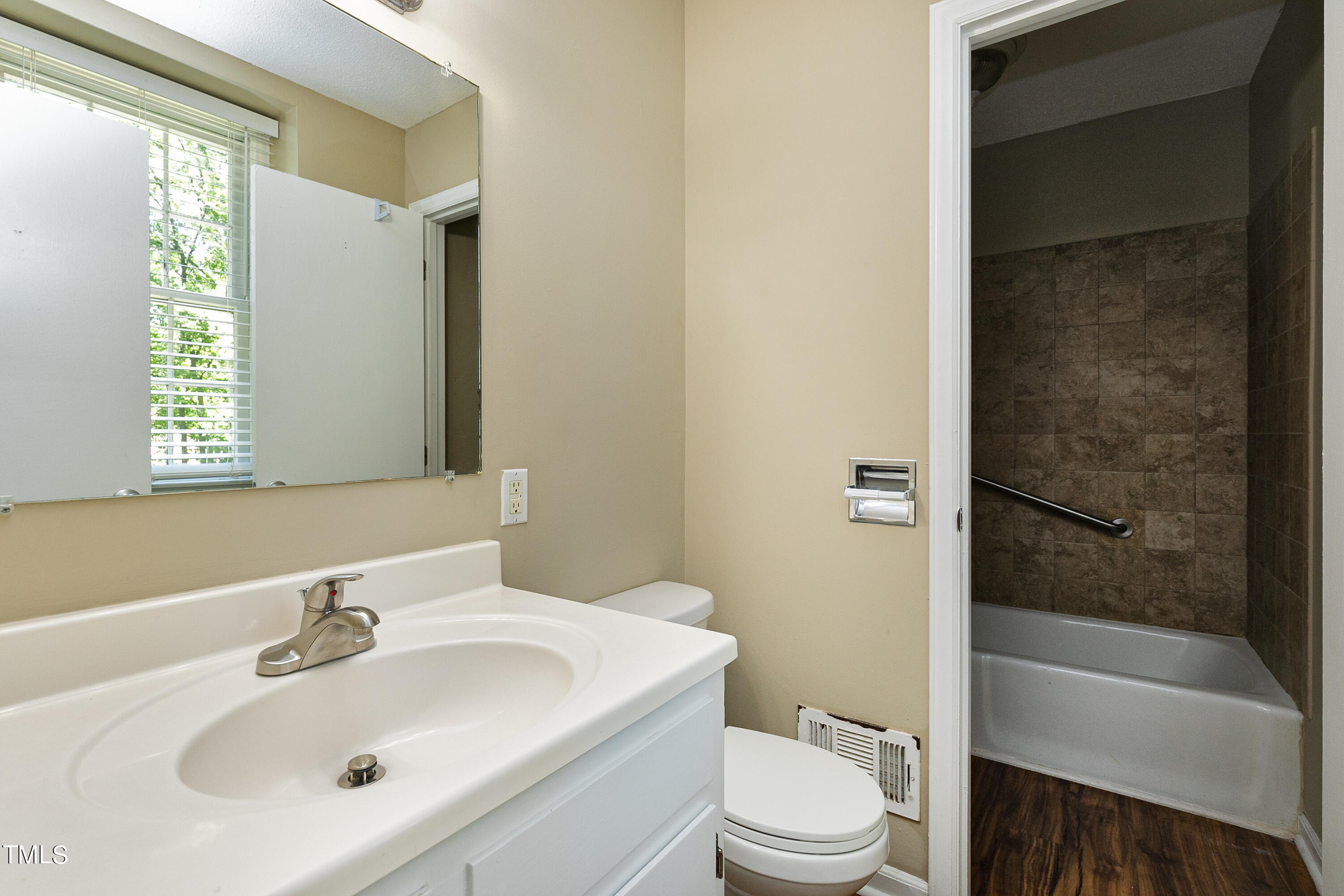 5841 Sandstone Drive Durham, NC 27713 - Photo 24 of 35 a bathroom with a sink toilet and shower