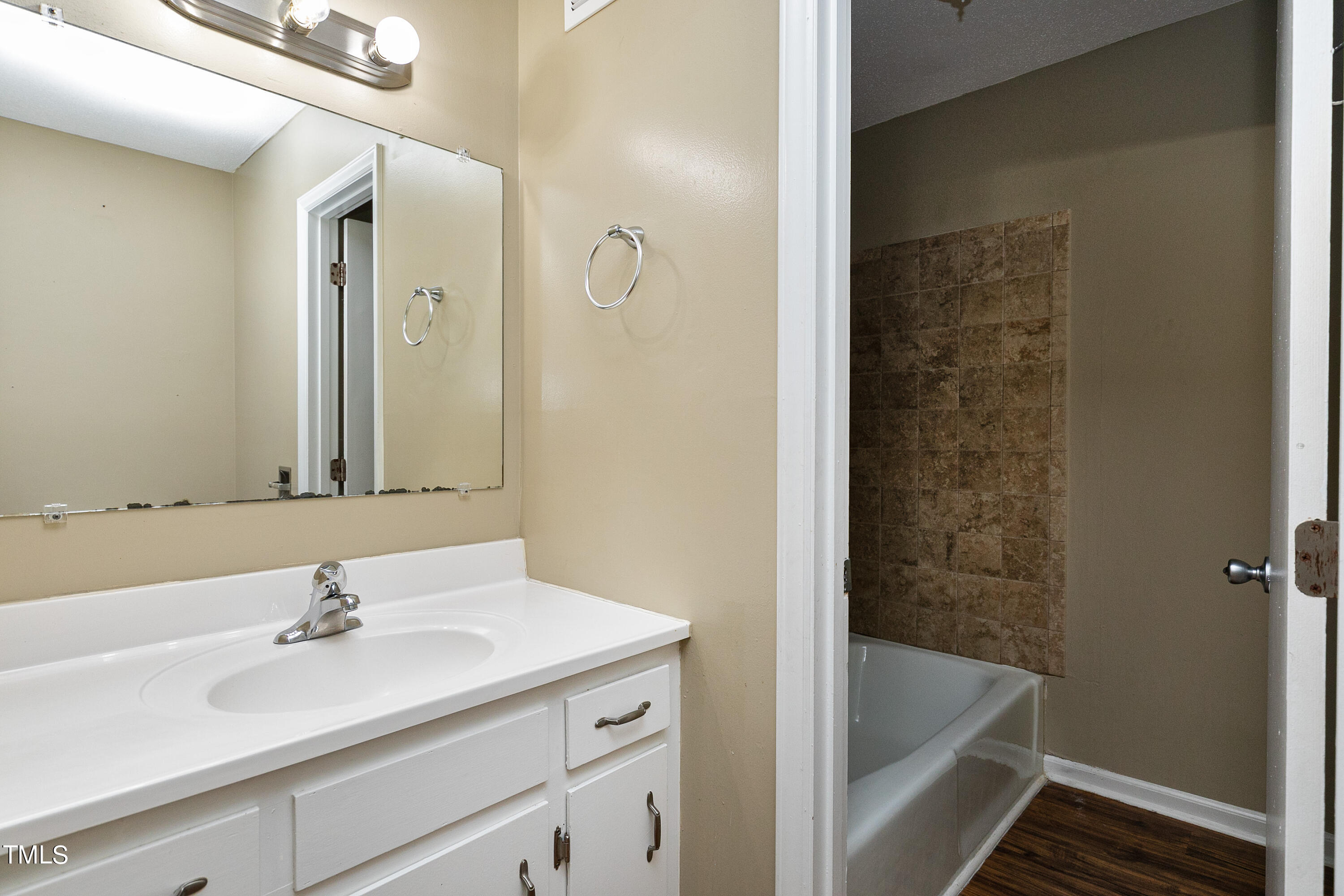 5841 Sandstone Drive Durham, NC 27713 - Photo 26 of 35 a bathroom with a sink and a bathtub