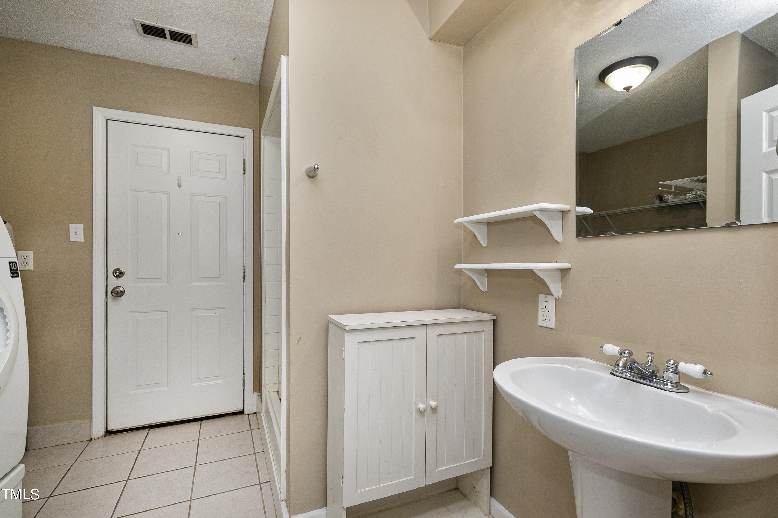 5841 Sandstone Drive Durham, NC 27713 - Photo 27 of 35 a bathroom with a sink toilet and mirror