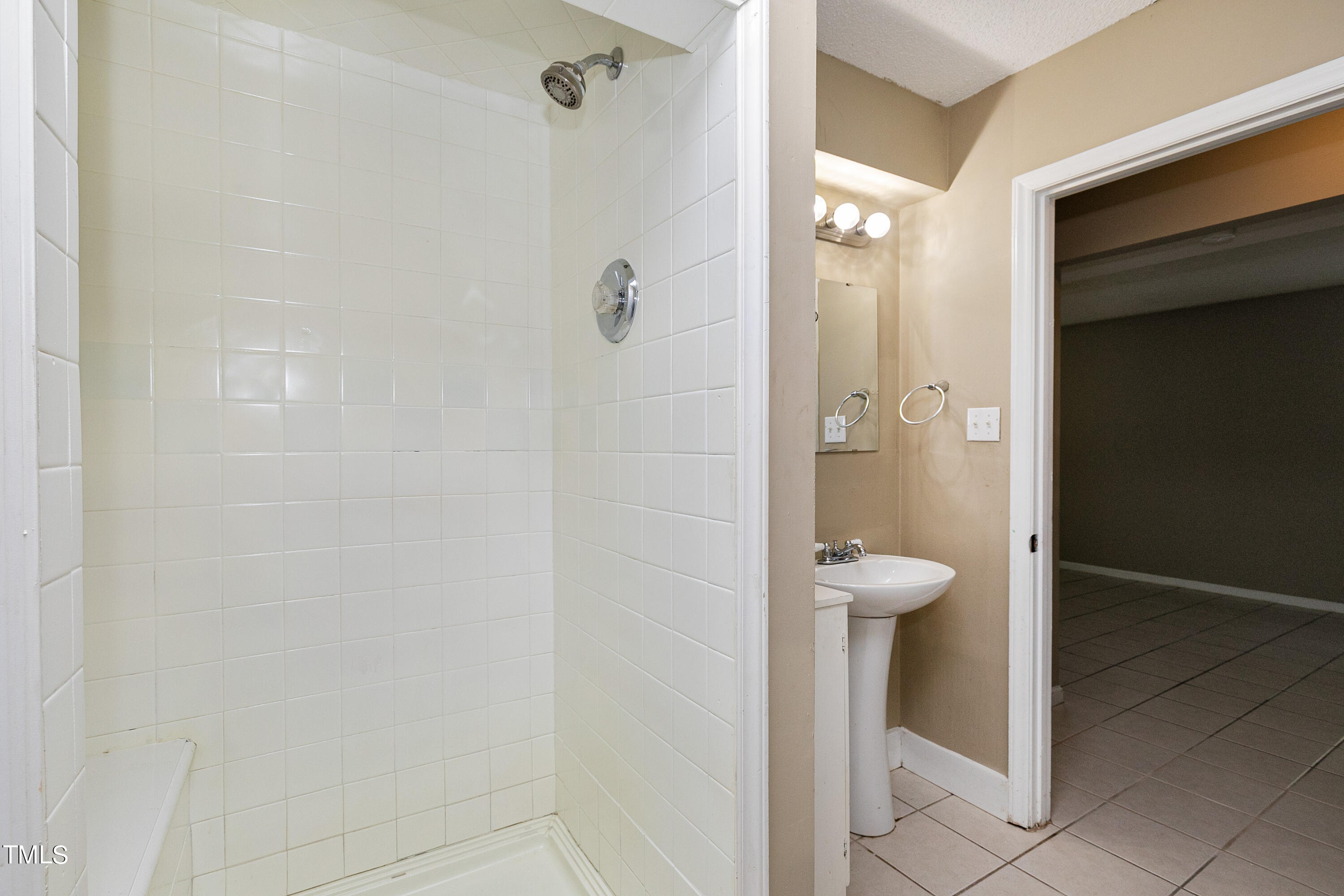 5841 Sandstone Drive Durham, NC 27713 - Photo 29 of 35 a bathroom with a sink and shower