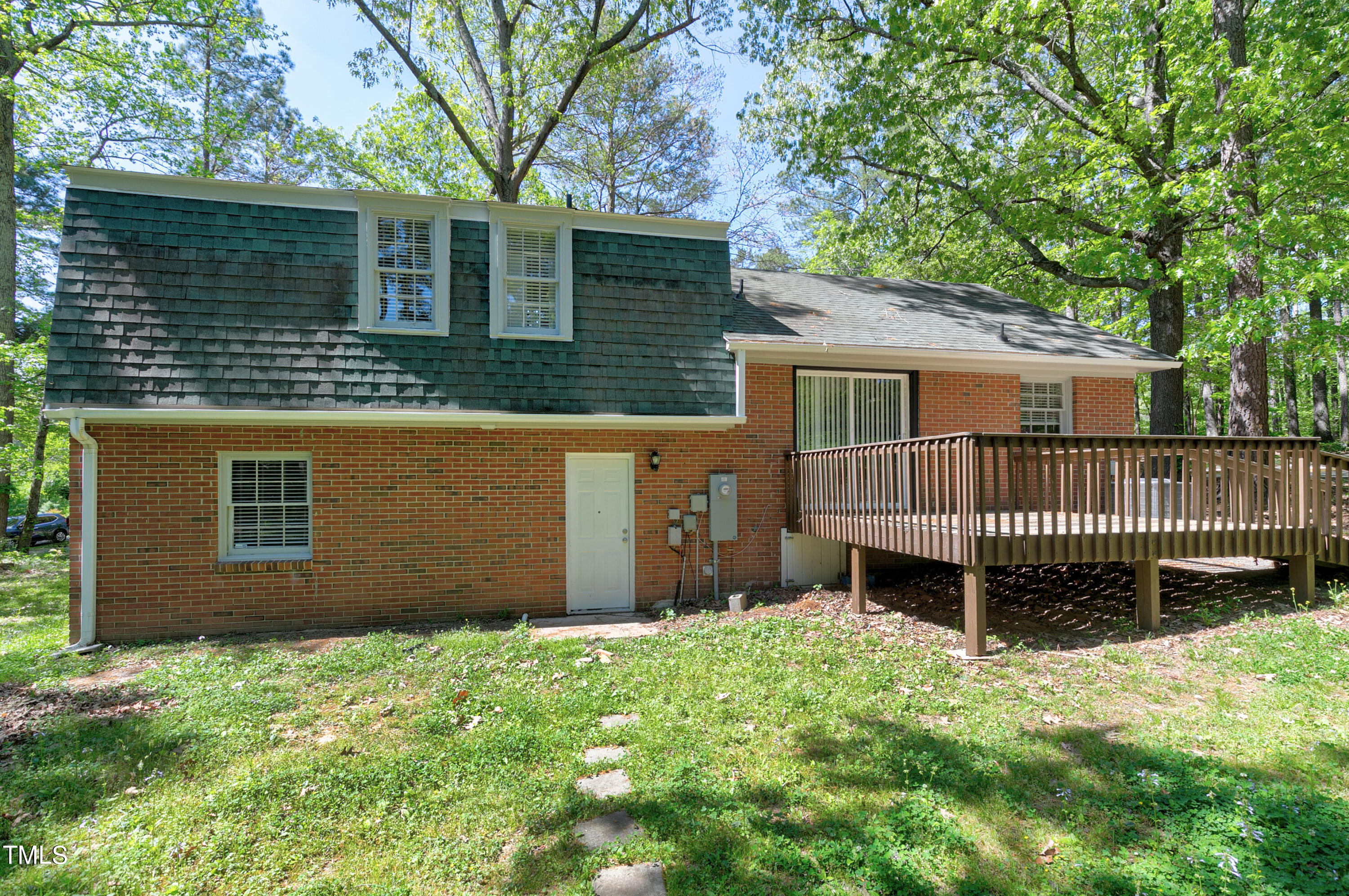 5841 Sandstone Drive Durham, NC 27713 - Photo 10 of 35 a view of a house with a yard and a large tree